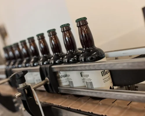 Tynt Medow Trappist ale bottles on production line at the brewery