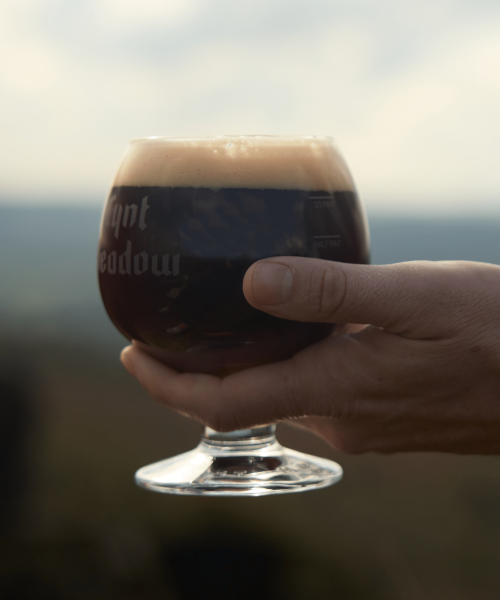 Tynt Meadow in branded glass, beautifully poured close up of hand