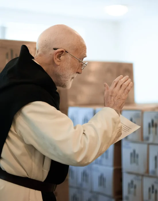 Mount St Bernard Abbey monk blessing cases of Tynt Meadow before they are dispatched